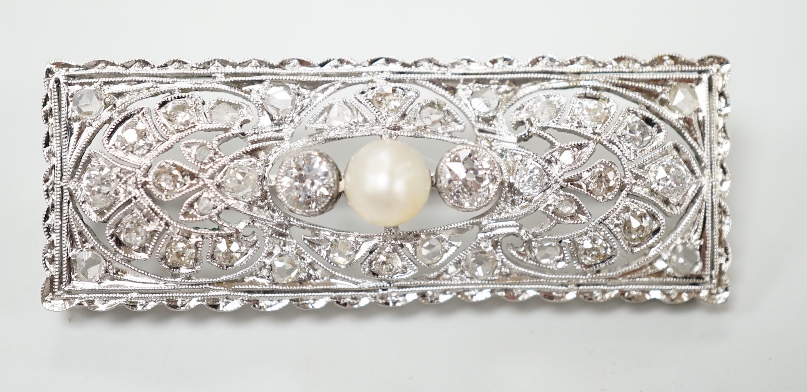 A 1920's white metal, pearl and diamond cluster set rectangular brooch, 43mm, gross weight 5.8 grams.